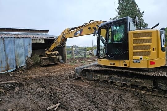 Excavator digging in wall